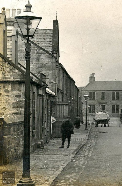 A fine series of gas lamps illuminating Church Street. Midcalder.